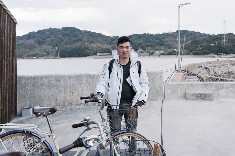 The author posing with a bike rented for transportation on the island of Naoshima in Japan